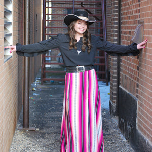 Model is wearing a black shirt and a pink and white striped skirt with a black Charlie One Horse Felt Hat